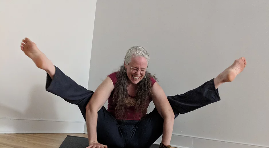 Kimberlyn laughing during yoga pose