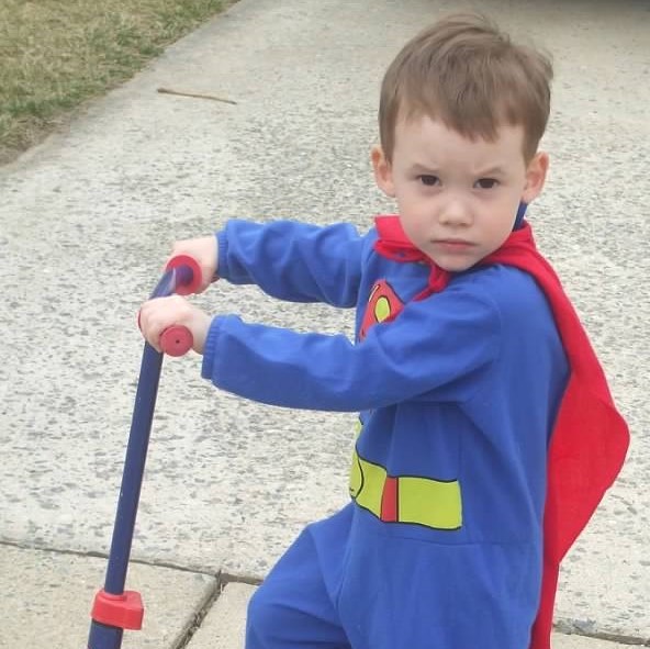 Little boy wearing a superman costume