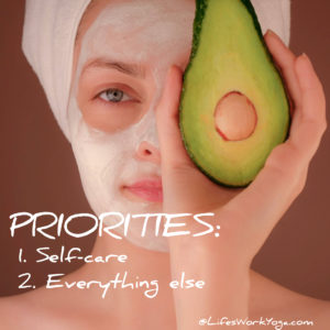 Woman holding avocado in front of face